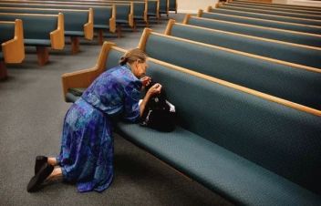 Woman prays in church
